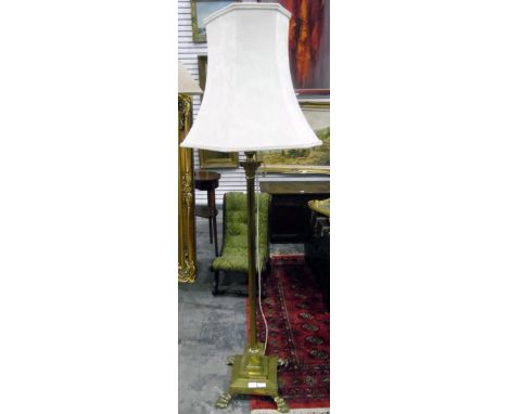 Brass lamp standard in the classical form, having reeded column with brass caps, on stepped square base with paw feet