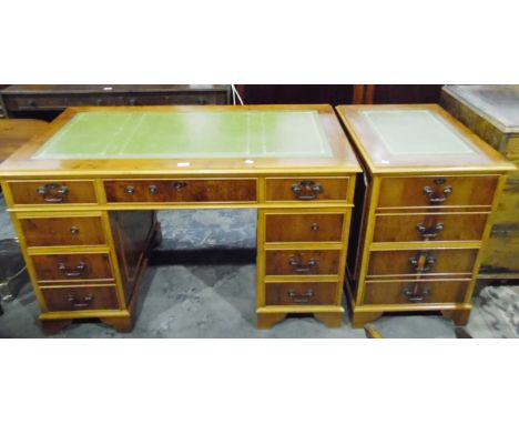 Modern yew wood veneer pedestal desk with inset writing surface,  three frieze drawers, with three further short drawers to e