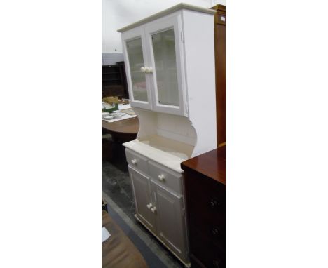 Modern white painted kitchen dresser with glazed cupboard above enclosing adjustable shelves, two frieze drawers and a pair o