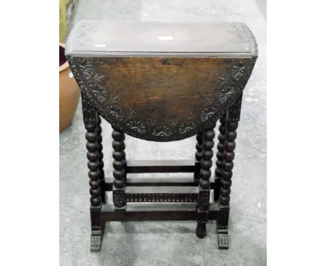 Late 19th century oak fall-flap Sutherland-style table with lunette carved border, fitted two drawers to frieze, on bobbin tu