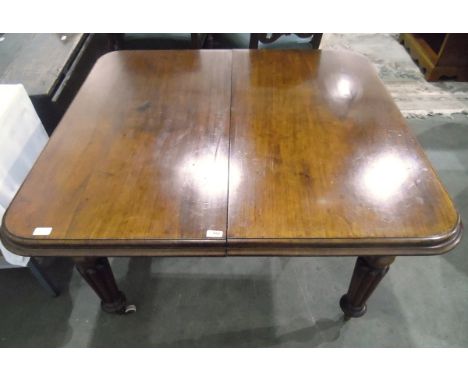 Victorian mahogany extending dining table with moulded edge, on turned reeded tapering legs with ceramic castors, with extra 