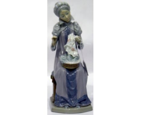 Lladro porcelain figure of lady in medieval dress, seated with sewing, 29cm high 