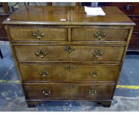 Reproduction walnut straight front chest of two short and three long graduated drawers, having pierced brass plates and bail 