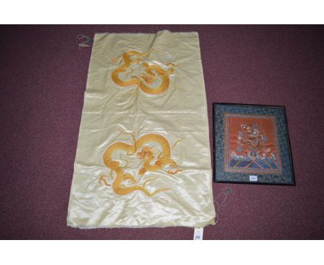 An early 20th Century Chinese yellow and orange silk embroidered panel with dragon design on pale yellow ground, 105 x 61cms 