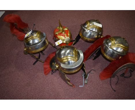 Reproduction helmets: four brass and steel Roman Centurion helmets with dyed red horse hair plumes; together with a red leath