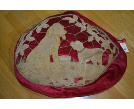 A 20th Century pouffe with applied dog decoration to red corduroy velvet.