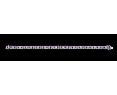  An 18 carat gold ruby and diamond bracelet,   the articulated bracelet composed of square shaped panels set with square cut 
