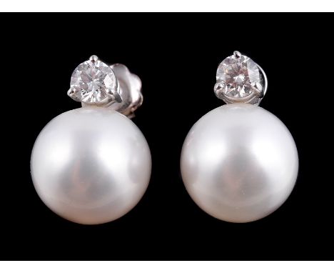  A pair of South Sea cultured pearl and diamond earrings,   the 1.2cm South Sea cultured pearls set below a brilliant cut dia