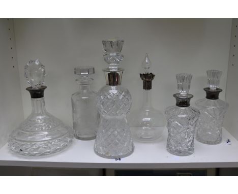 Good collection of Silver Rimmed Cut Glass decanters and a etched glass African design decanter 