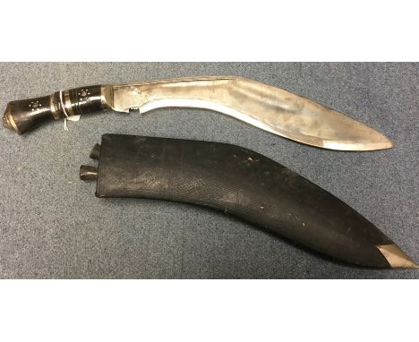 Kukri knife with 34.5cm long bright steel blade marked "India". Overall length 46cm. Lions head pommel. Complete with black l