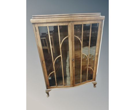 An Art Deco walnut serpentine fronted cabinet, width 91 cm