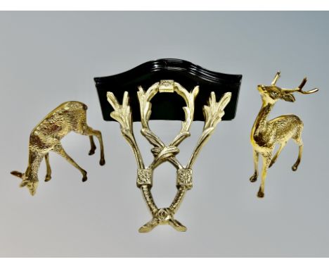 A brass and wood clock bracket and pair of brass figures of deer 