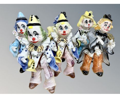 Seven ceramic clown ornaments  CONDITION REPORT: Some with damages.