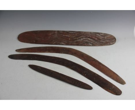 Two Australian Aboriginal boomerangs, 72cm and 71cm, with a smaller carved paddle and a carved wood oval shield, 71.5cm (4)