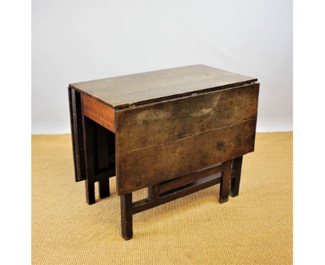 A George III provincial oak gate leg table, with three plank top, on square legs, 73cm H x 92cm W x 53cm D when closed