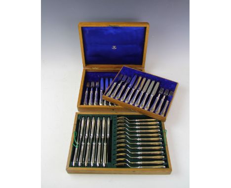 A cased set of twelve silver George V Mappin &amp; Webb dessert knives and forks, Sheffield 1915, within an oak cased canteen