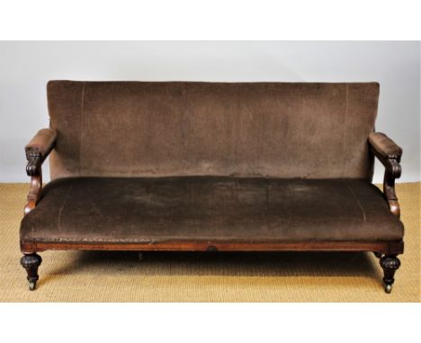 A Victorian walnut salon sofa, with brown upholstery and scroll end arms, on turned and gadrooned legs, 79cm H x 165cm W x 75