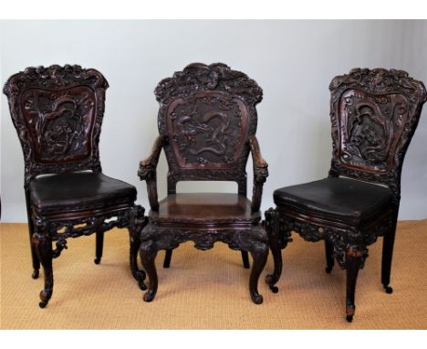 A Chinese carved softwood circular dining table, the top decorated with a central dragon within a border of clouds, with pier