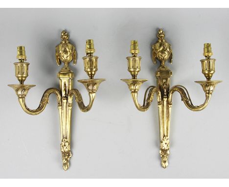 A pair of George III style gilt brass twin branch wall lights, the tapering back plates surmounted by flaming urns, 36.5cm (2