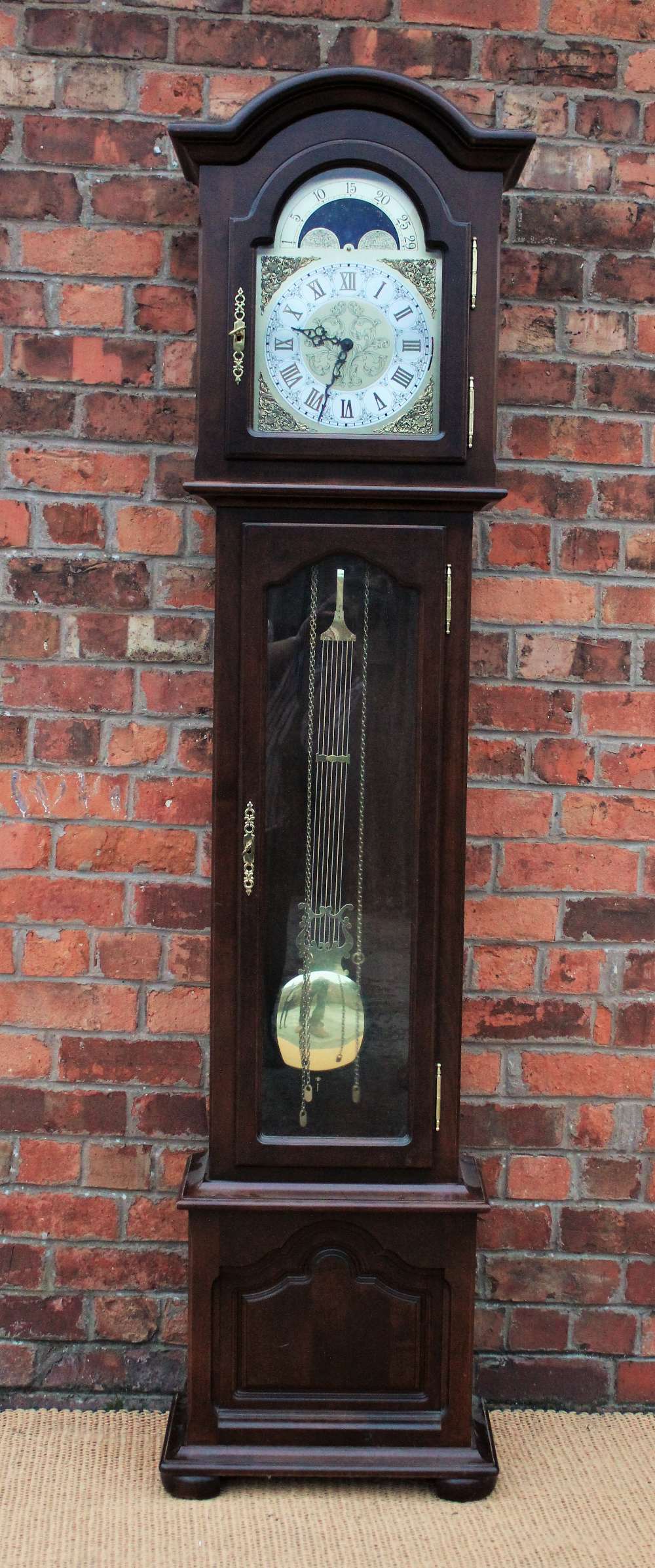 An modern Interclock longcase clock, with Roman numeral dial and