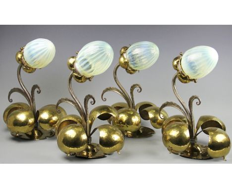 An impressive set of four Arts and Crafts wall lights possibly Birmingham Guild of Handicraft, each modelled as a flower, wit