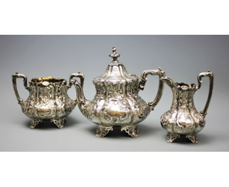 A Victorian three piece silver tea service, Joseph Angell II London 1856, each piece of melon form and busily embossed and en