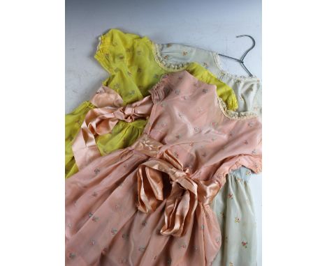 Three early 20th century girls day dresses, age approx 2/3, each in a different pastel tone, with rose sprigged embroidery, l