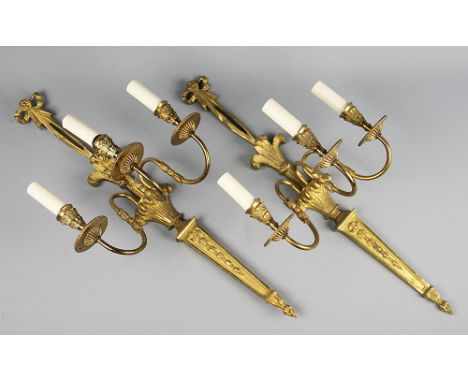 A set of three George III style gilt brass three branch wall lights, the back plates cast with bow tied ribbons, Prince Of Wa