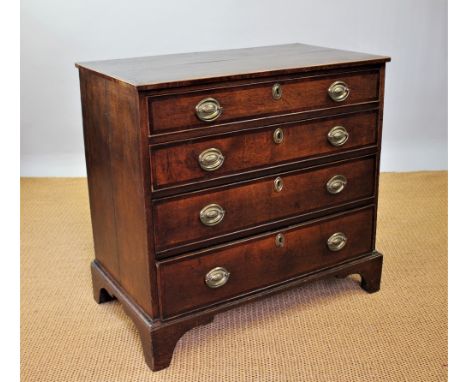 A George III oak and mahogany cross banded chest, of four graduated long drawers, on bracket feet, 82cm H x 88cm W x 49cm D  