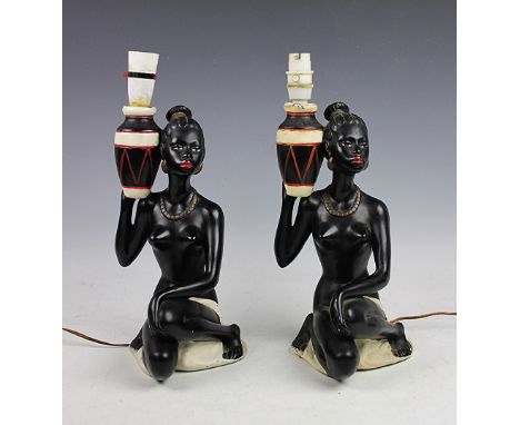 A pair of mid-century design figural lamp bases, each modelled as nude female attendants, Reg No.893599, 31cm high excluding 