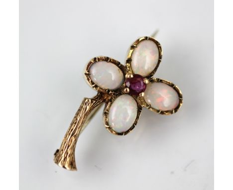 An opal and ruby set floral brooch, deisgned as a four 'petalled' flower each set with an opal and with central ruby, all set