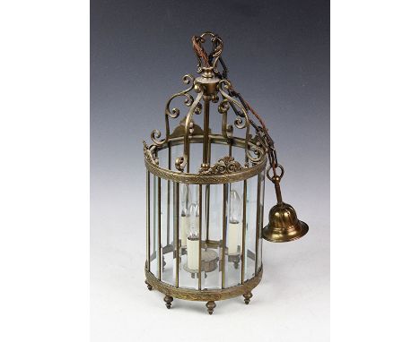 A gilt brass cylindrical hall lantern, with scroll top and sixteen bevelled glass panels, 51cm  CONDITION REPORT: Lighting lo