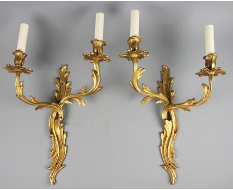 A pair of Louis XV style gilt brass twin branch wall  lights, with serpentine back plates, 42cm (2) CONDITION REPORT: Lightin