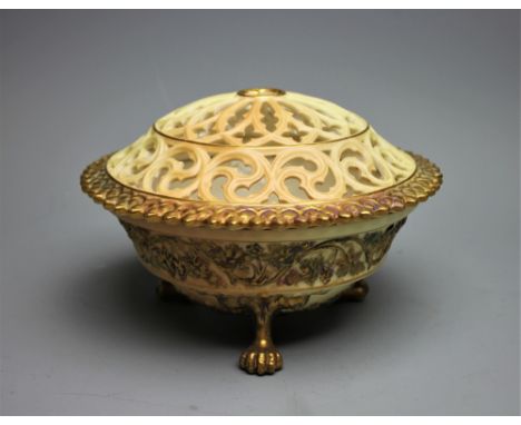 A Royal Worcester blush ivory potpourri bowl and cover, shape number G846, decorated with fruiting vines, on three lions paw 