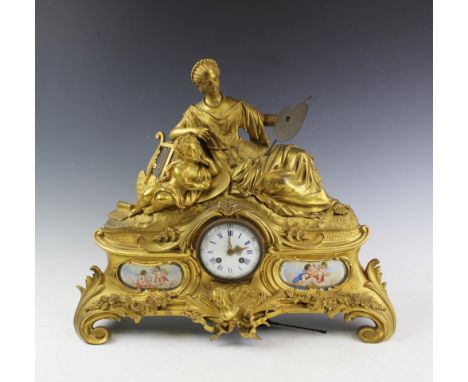 A 19th century gilt metal eight day mantel clock, with enamel Roman numeral dial and movement striking on a bell, the case mo