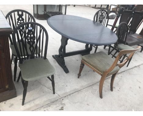 A (POSSIBLY ERCOL) DROP LEAF DINING TABLE, FOUR WHEELBACK DINING CHAIRS AND A FURTHER MAHOGANY DINING CHAIR 