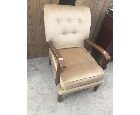 AN OAK ARMCHAIR WITH BUTTON BACK UPHOLSTERY 