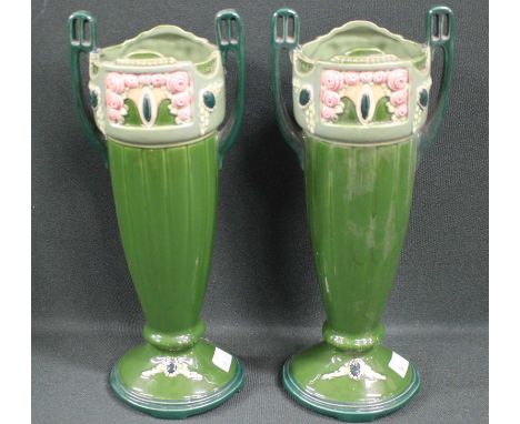 A pair of Eichwald Art Nouveau/Secessionist green twin handled vases moulded mark and number 928, 31cm high