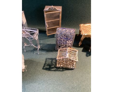 Antique soft metal dolls house miniature Furniture and accessories to include cabinets , dolls cot with drapes and a small fr
