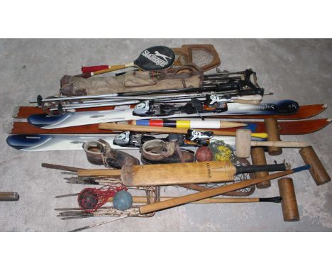 Collection of vintage sporting equipment to include 2 sets of skis set of golf clubs and other related items.