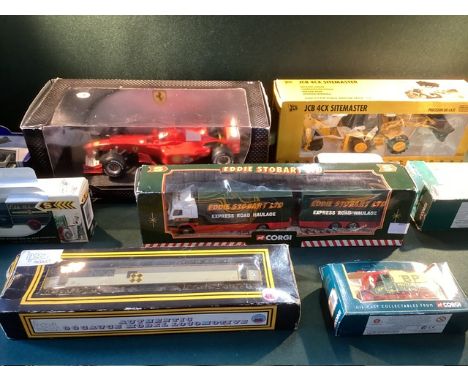 Toy boxed model cars and train carriage, to include a mini champs larger scale green vintage car, a digger and an Eddie Stobb