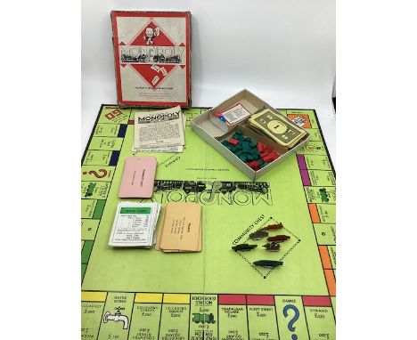    Vintage early John waddington Monopoly with metal war time ship playing pieces and Ogden houses-cards and board-early vers