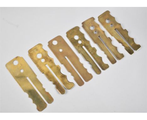 A Collection of Six Vintage Brass Button Polishing Guards 