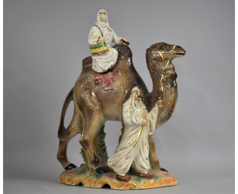 A Large Mid 20th Century Glazed Ceramic Figure Group, Arabic Woman Riding Camel with Gent Leading, 52cm high 