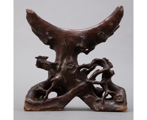 Wooden stand, made to look like flowering branches of a tree, designed to hold a round, flat object such as a large jade Bi o