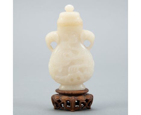 A very well carved 19th c. Chinese white jade covered vase. Excellent quality of carving on the body of the vase as well as t