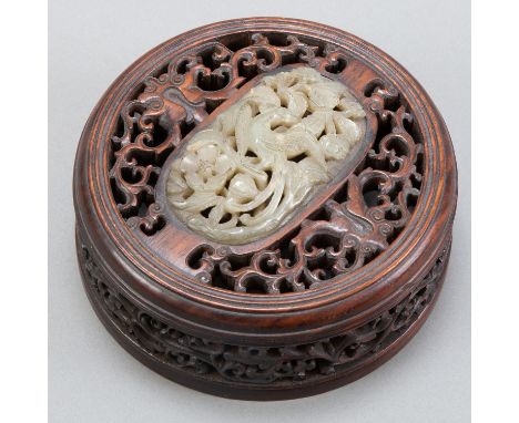 Lovely for several reasons, this early Chinese jade was mounted in the 19th century into a stunning carved wooden replacement