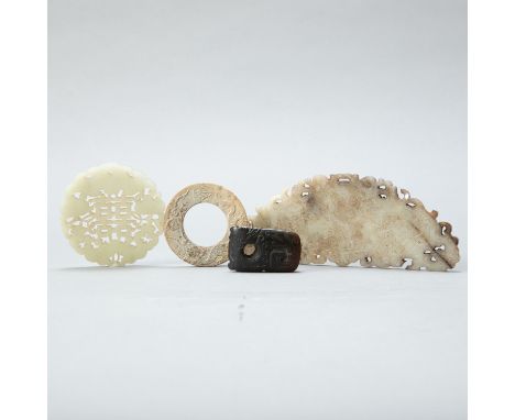 Group of four Chinese 20th century jade carvings. One pierced pale green jade pendant; one circular jade pendant with a drago