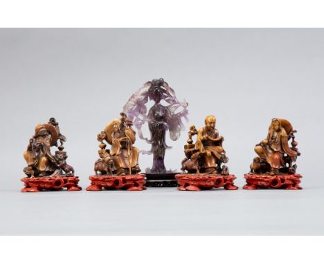 An excellent grouping of Chinese soap stone immortals also with an amethyst carving of a woman. All with custom wooden stands