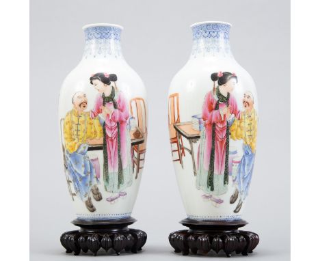 Pair Chinese Republic Period famille rose porcelain vases in baluster form decorated with a domestic scene and a poem. Unders